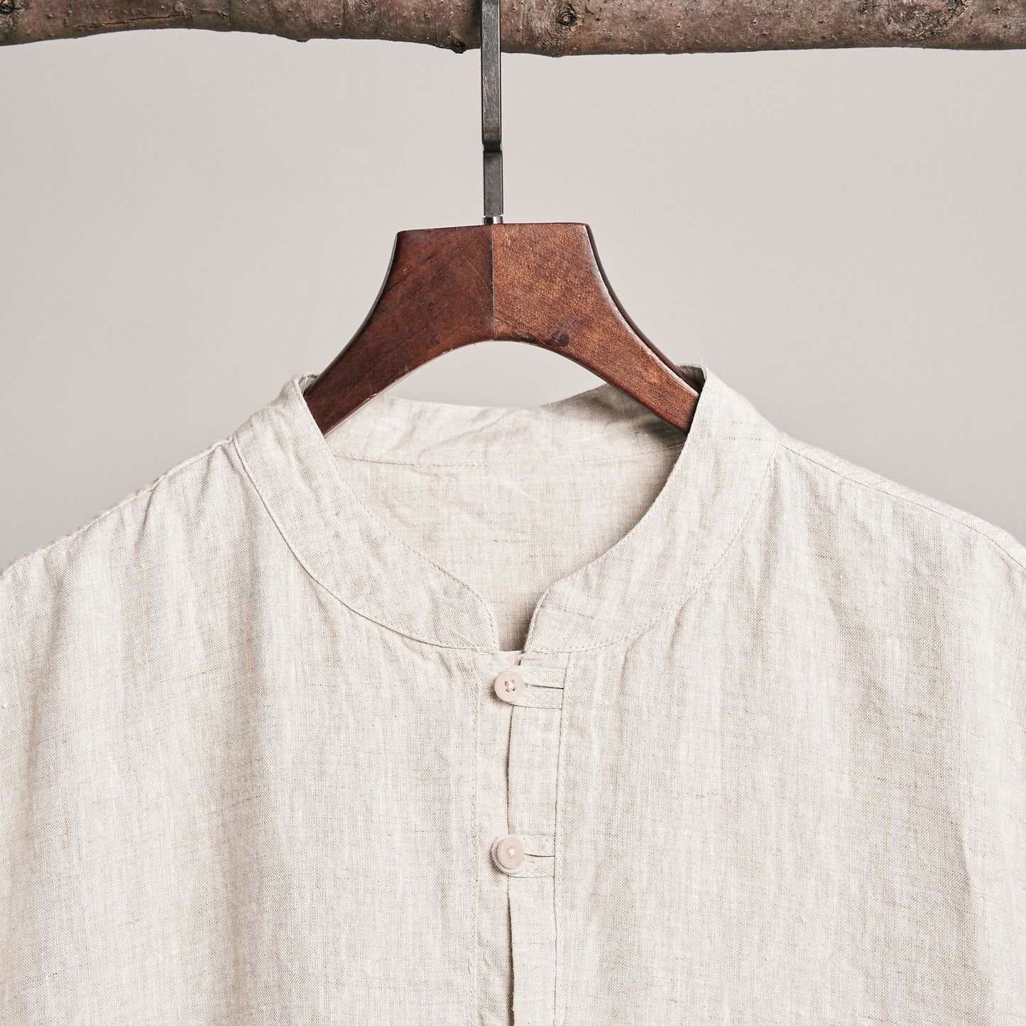Natural linen button shirt on a hanger