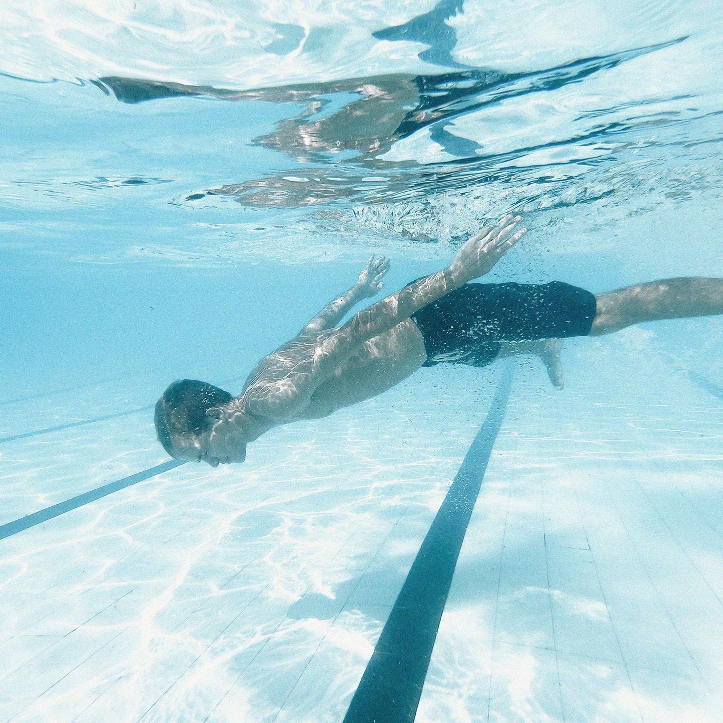 Swimmer in swim shorts underwater